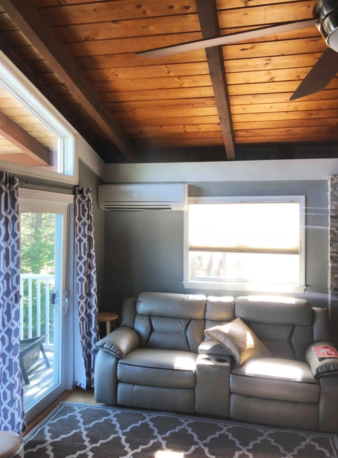 Living room with large windows and couch.