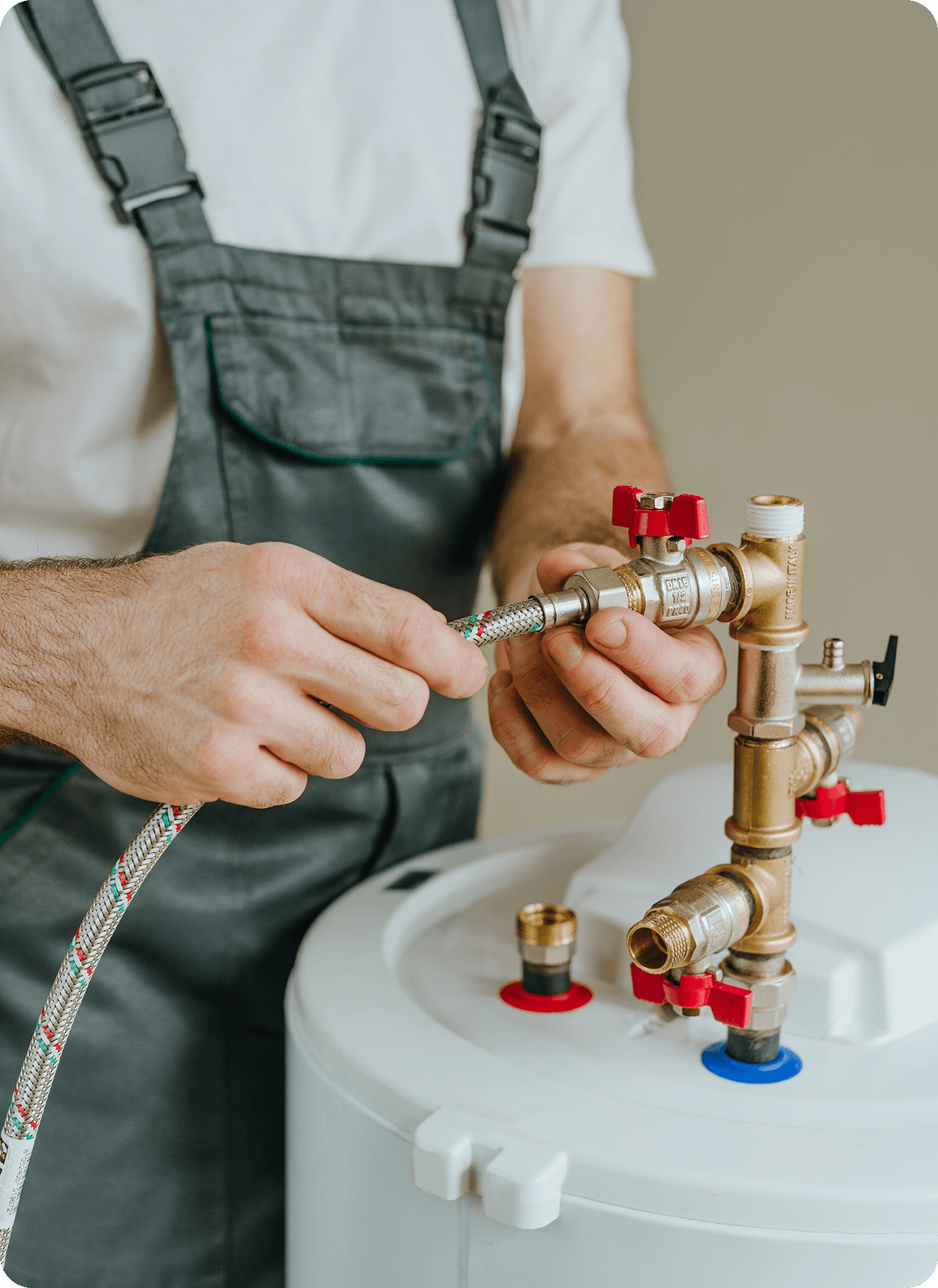 Plumber installing water heater connections.