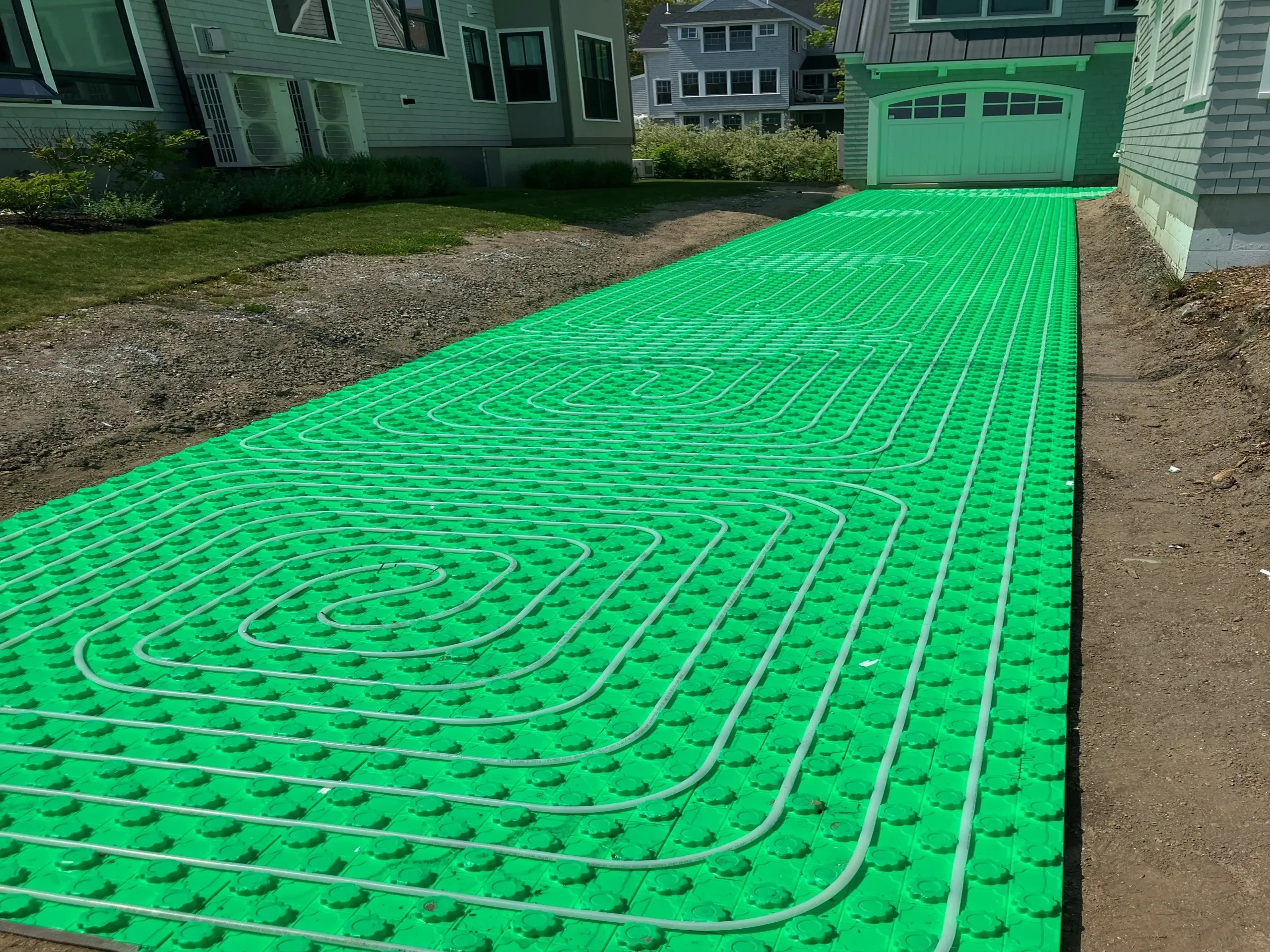 Green radiant heating system on driveway installation.